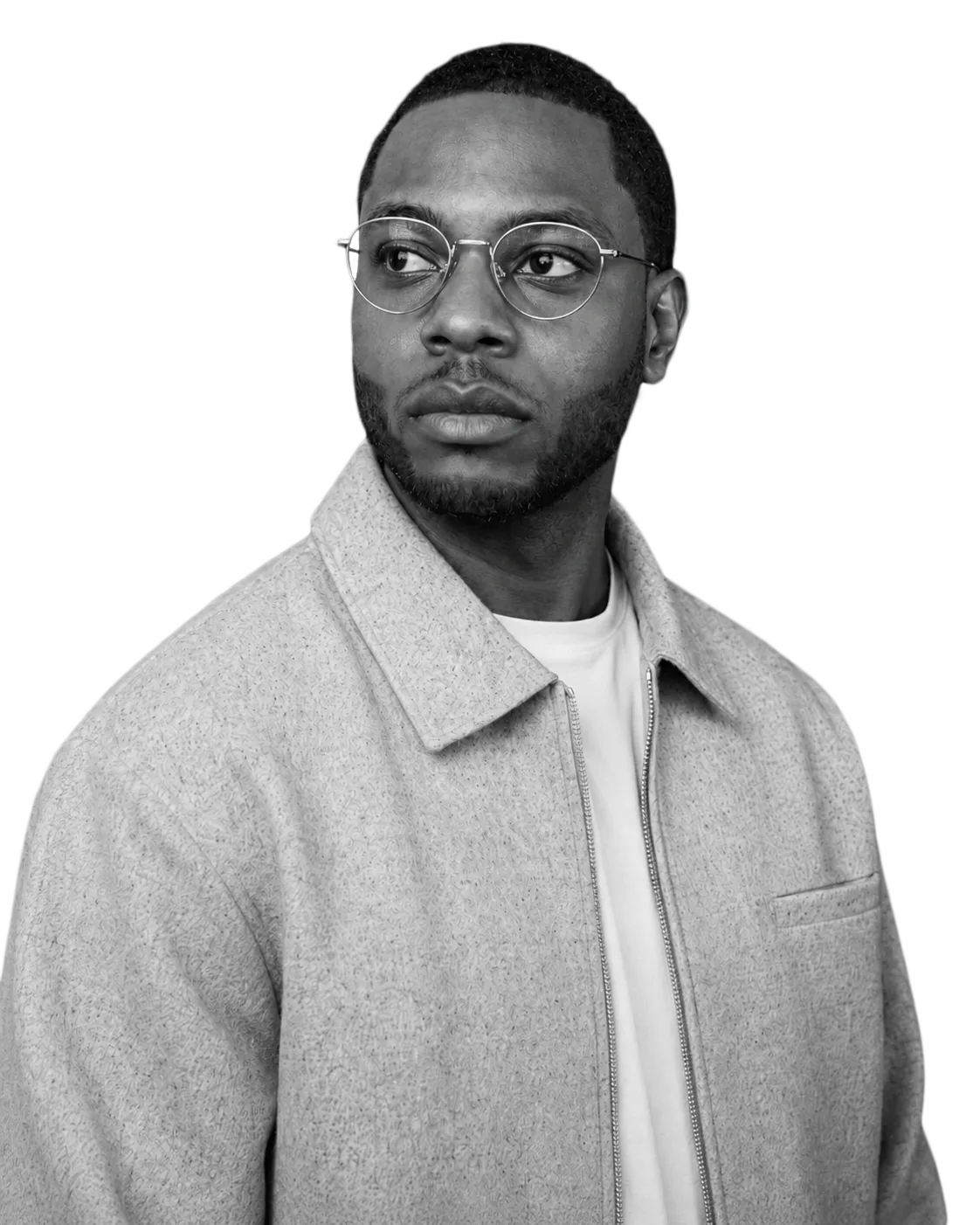 Black-and-white portrait of Nick wearing glasses and a light jacket.